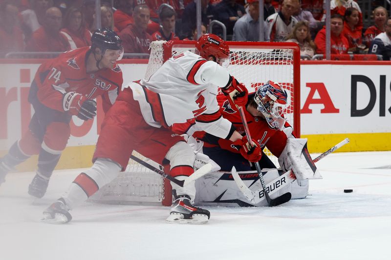 May 6, 2025; Washington, District of Columbia, USA; Washington Capitals goaltender Logan Thompson (48) makes a save on Carolina Hurricanes right wing Andrei Svechnikov (37) as Capitals defenseman John Carlson (74) defends in the second period in game one of the second round of the 2025 Stanley Cup Playoffs at Capital One Arena. Mandatory Credit: Geoff Burke-Imagn Images