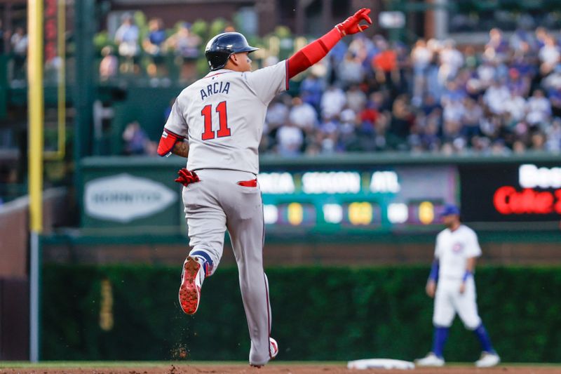 May 21, 2024; Chicago, Illinois, USA; Atlanta Braves shortstop Orlando Arcia (11) rounds the bases after hitting a two-run home run against the Chicago Cubs during the second inning at Wrigley Field. Mandatory Credit: Kamil Krzaczynski-USA TODAY Sports