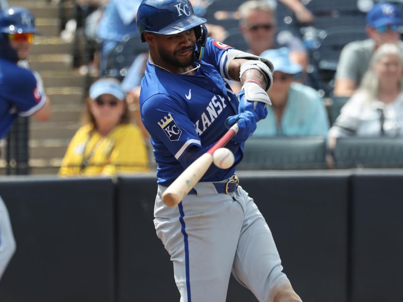 May 1, 2025; St. Petersburg, Florida, USA;  Kansas City Royals third base Maikel Garcia (11) hits an RBI single during the eighth inning against the Tampa Bay Rays at George M. Steinbrenner Field. Mandatory Credit: Kim Klement Neitzel-Imagn Images