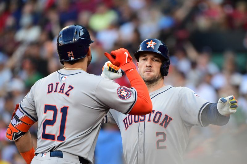 Aug 10, 2024; Boston, Massachusetts, USA;  Houston Astros designated hitter Yainer Diaz (21) reacts with third baseman Alex Bregman (2) after Bregman hit a home run during the seventh inning against the Boston Red Sox at Fenway Park. Mandatory Credit: Bob DeChiara-USA TODAY Sports