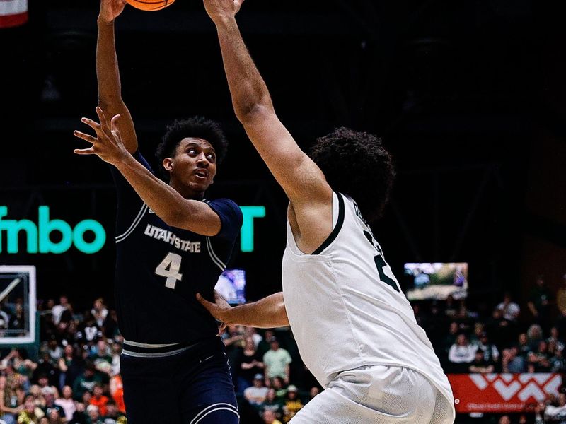 Mar 1, 2025; Fort Collins, Colorado, USA; Utah State Aggies guard Ian Martinez (4) passes the ball under pressure from Colorado State Rams forward Rashaan Mbemba (21) in the second half at Moby Arena. Mandatory Credit: Isaiah J. Downing-Imagn Images