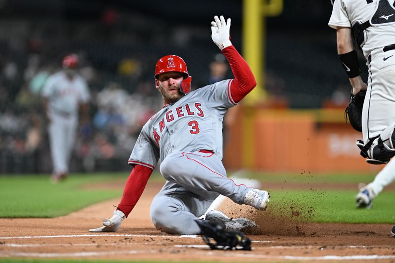 Aug 27, 2024; Detroit, Michigan, USA;  Los Angeles Angels left fielder Taylor Ward (3) slides home safely to score a run against the Detroit Tigers in the first inning at Comerica Park. Mandatory Credit: Lon Horwedel-USA TODAY Sports