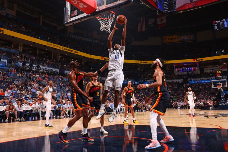 OKLAHOMA CITY, OK - APRIL 14: Olivier Maxence-Prosper #18 of the Dallas Mavericks shoots the ball during the game against the Oklahoma City Thunder  on April 14, 2024 at Paycom Arena in Oklahoma City, Oklahoma. NOTE TO USER: User expressly acknowledges and agrees that, by downloading and or using this photograph, User is consenting to the terms and conditions of the Getty Images License Agreement. Mandatory Copyright Notice: Copyright 2024 NBAE (Photo by Zach Beeker/NBAE via Getty Images)