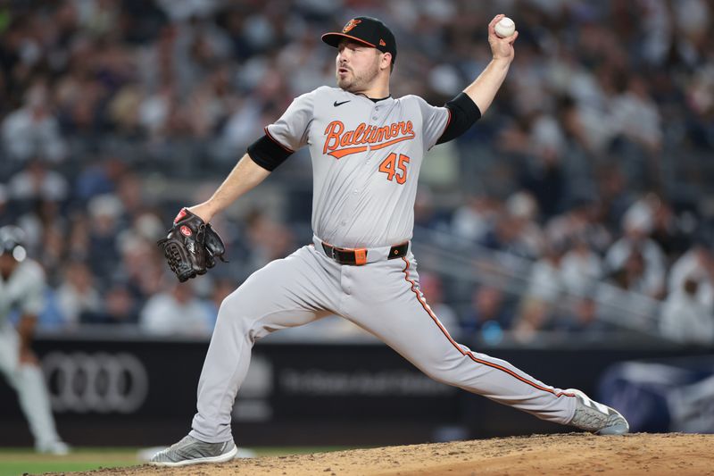 Jun 18, 2024; Bronx, New York, USA; Baltimore Orioles relief pitcher Keegan Akin (45) delivers a pitch during the sixth inning against the New York Yankees at Yankee Stadium. Mandatory Credit: Vincent Carchietta-USA TODAY Sports