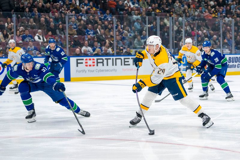 Jan 3, 2025; Vancouver, British Columbia, CAN; Nashville Predators defenseman Spencer Stastney (24) shoots against Vancouver Canucks defenseman Tyler Myers (57) in the first period at Rogers Arena. Mandatory Credit: Bob Frid-Imagn Images