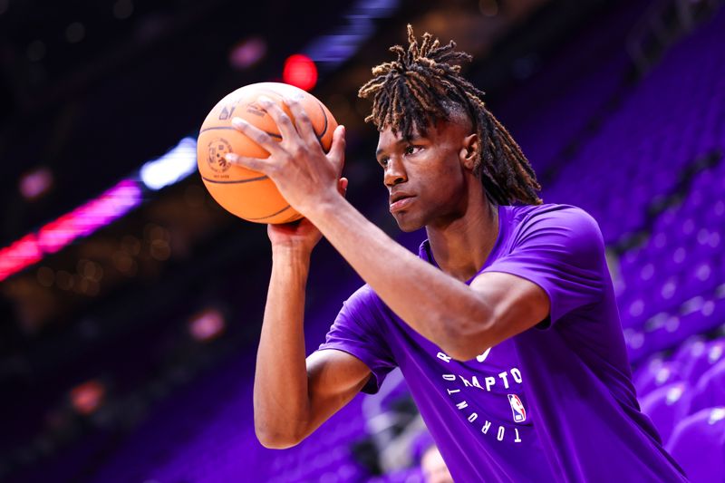 TORONTO, CANADA - OCTOBER 23: Ja'Kobe Walter #14 of the Toronto Raptors warms up before the game against the Cleveland Cavaliers on October 23, 2024 at the Scotiabank Arena in Toronto, Ontario, Canada.  NOTE TO USER: User expressly acknowledges and agrees that, by downloading and or using this Photograph, user is consenting to the terms and conditions of the Getty Images License Agreement.  Mandatory Copyright Notice: Copyright 2024 NBAE (Photo by Vaughn Ridley/NBAE via Getty Images)