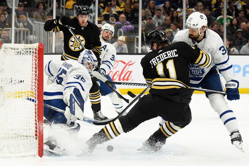 Apr 20, 2024; Boston, Massachusetts, USA; Boston Bruins center Trent Frederic (11) looks for a rebound in front of Toronto Maple Leafs goaltender Ilya Samsonov (35) during the first period in game one of the first round of the 2024 Stanley Cup Playoffs at TD Garden. Mandatory Credit: Bob DeChiara-USA TODAY Sports