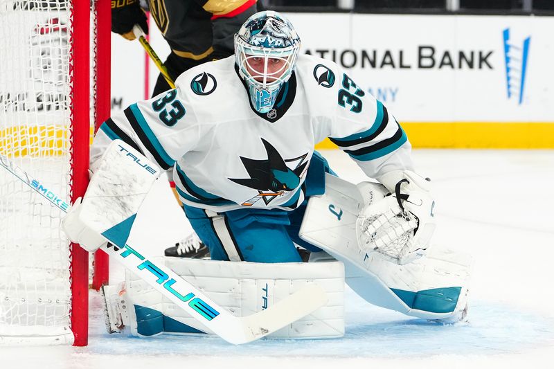 Nov 29, 2025; Las Vegas, Nevada, USA; San Jose Sharks goaltender Alex Nedeljkovic (33) defends his net against the Vegas Golden Knights during the first period at T-Mobile Arena. Mandatory Credit: Stephen R. Sylvanie-Imagn Images