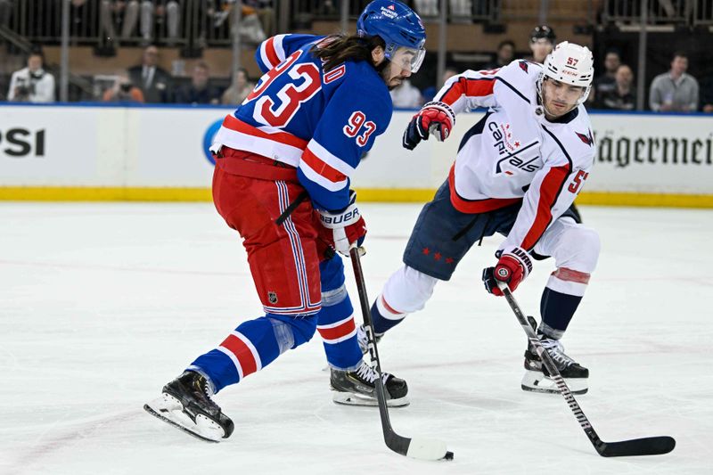 Apr 23, 2024; New York, New York, USA;  New York Rangers center Mika Zibanejad (93) attempts a shot defended by Washington Capitals defenseman Trevor van Riemsdyk (57) during the first period in game two of the first round of the 2024 Stanley Cup Playoffs at Madison Square Garden. Mandatory Credit: Dennis Schneidler-USA TODAY Sports