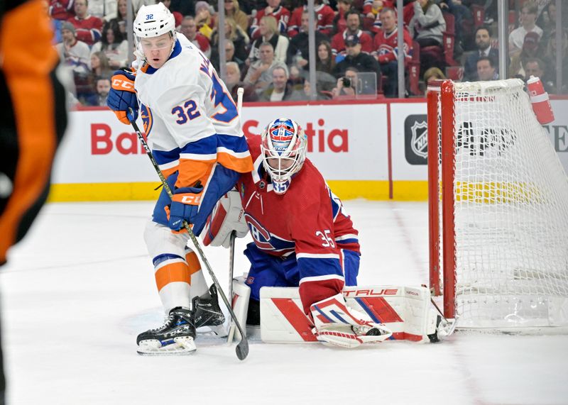 Jan 25, 2024; Montreal, Quebec, CAN; Montreal Canadiens goalie Sam Montembeault (35) makes a glove save next to New York Islanders forward Kyle MacLean (32) during the second period at the Bell Centre. Mandatory Credit: Eric Bolte-USA TODAY Sports