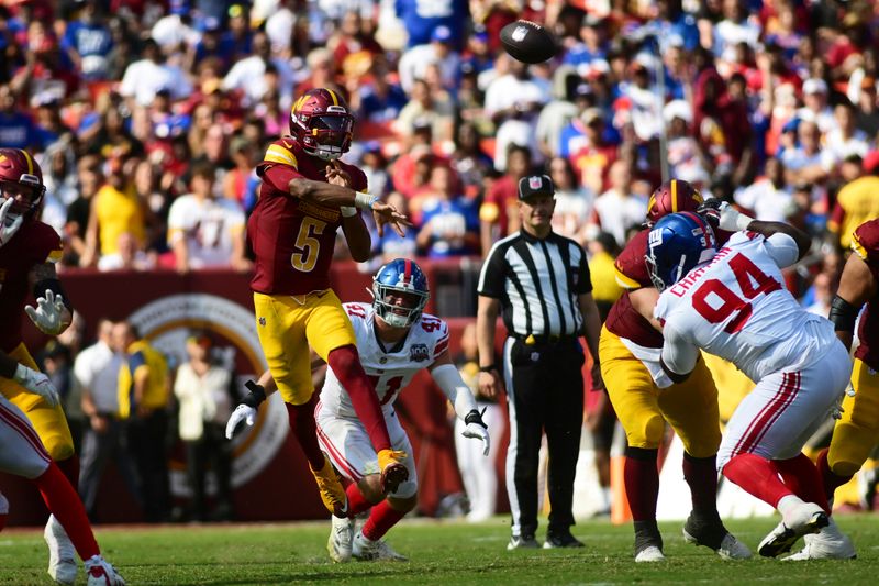 Washington Commanders quarterback Jayden Daniels (5) throws a pass against the New York Giants during the second half of an NFL football game in Landover, Md., Sunday, Sept. 15, 2024. (AP Photo/Steve Ruark)