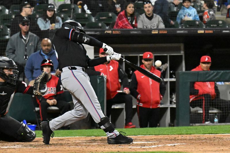 May 9, 2025; Chicago, Illinois, USA;  Miami Marlins catcher Liam Hicks (34) hits a homerun against the Chicago White Sox during the seventh inning at Rate Field. Mandatory Credit: Matt Marton-Imagn Images