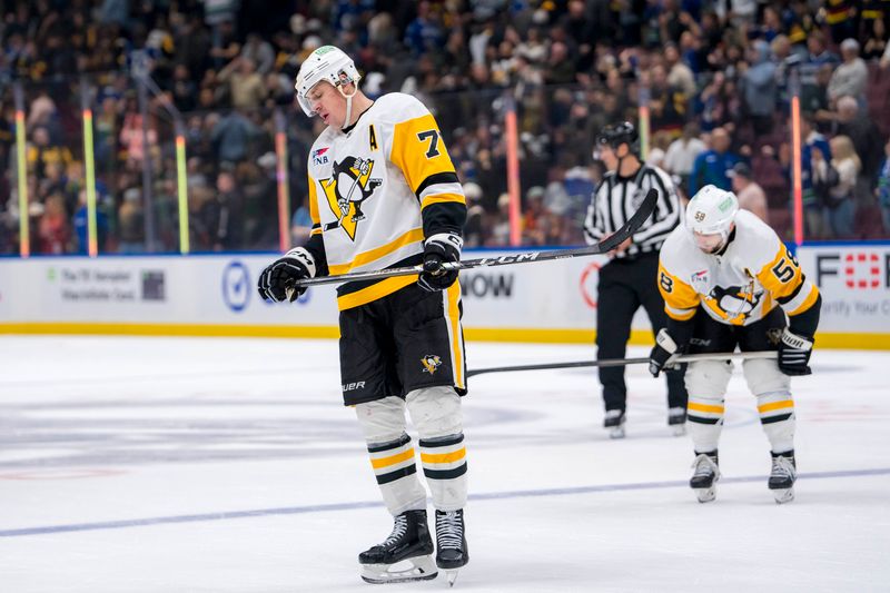 Oct 26, 2024; Vancouver, British Columbia, CAN; Pittsburgh Penguins defenseman Kris Letang (58) and forward Evgeni Malkin (71) react after losing to the Vancouver Canucks at Rogers Arena. Mandatory Credit: Bob Frid-Imagn Images