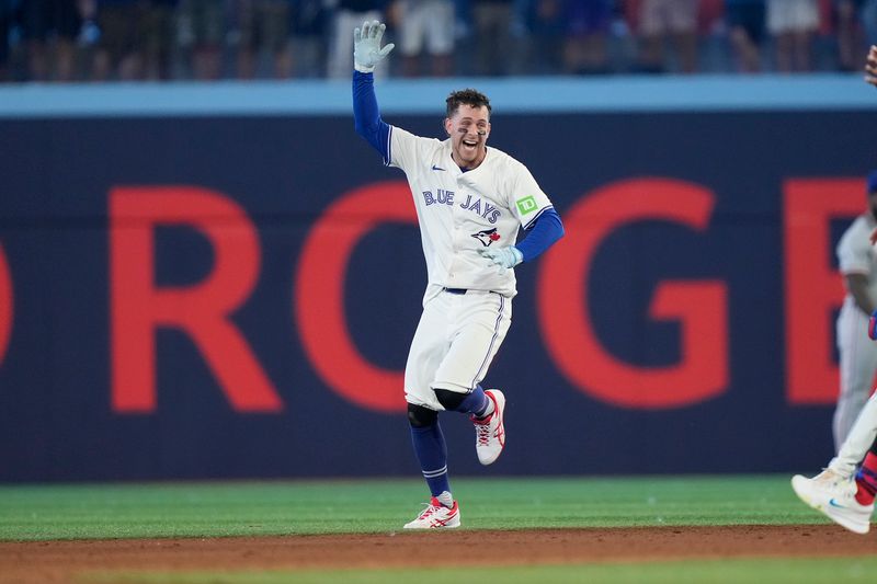 Jul 26, 2024; Toronto, Ontario, CAN; Toronto Blue Jays third baseman Ernie Clement (28) celebrates his walk off single to win the game against he Texas Rangers in the ninth inning at Rogers Centre. Mandatory Credit: John E. Sokolowski-USA TODAY Sports