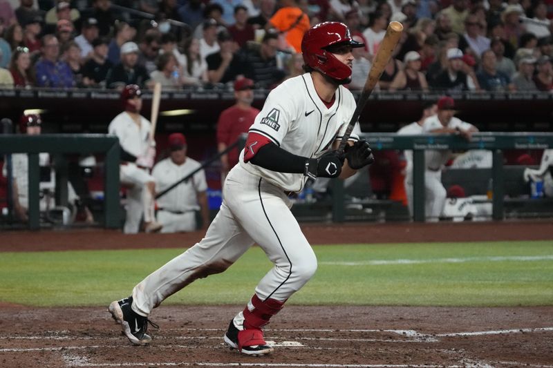 Aug 11, 2024; Phoenix, Arizona, USA; Arizona Diamondbacks catcher Adrian Del Castillo (25) hits a two-run single against the Philadelphia Phillies in the third inning at Chase Field. Mandatory Credit: Rick Scuteri-USA TODAY Sports
