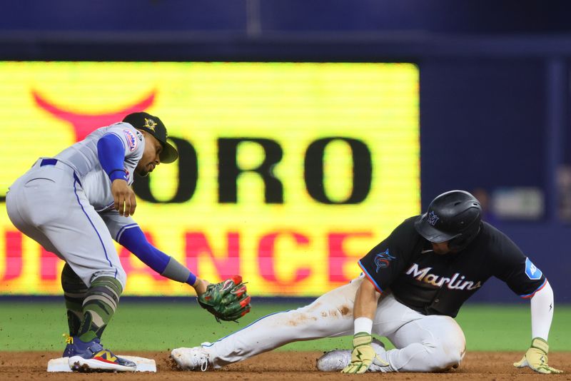 May 17, 2024; Miami, Florida, USA; Miami Marlins third baseman Jake Burger (36) slides at second base after hitting a double against the New York Mets during the fifth inning at loanDepot Park. Mandatory Credit: Sam Navarro-USA TODAY Sports