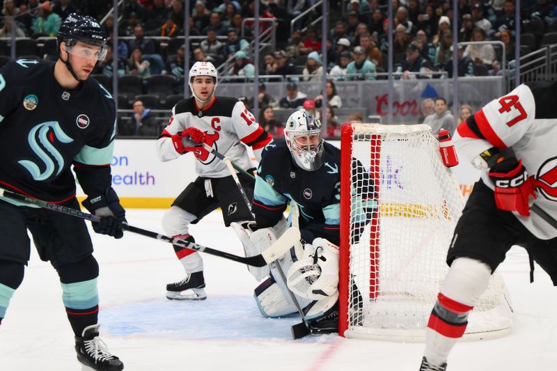 Jan 6, 2025; Seattle, Washington, USA; Seattle Kraken goaltender Philipp Grubauer (31) defends the goal against the New Jersey Devils during the second period at Climate Pledge Arena. Mandatory Credit: Steven Bisig-Imagn Images