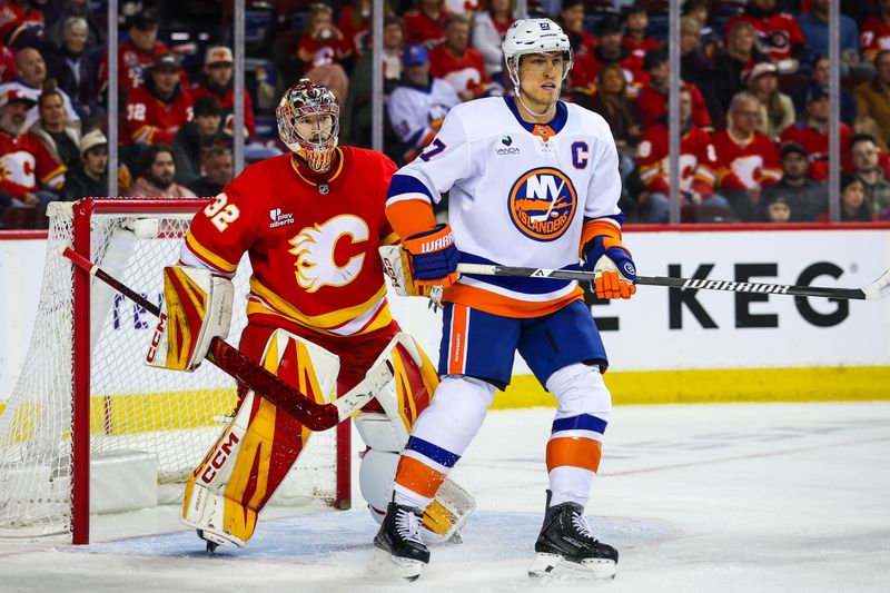 Jan 17, 2026; Calgary, Alberta, CAN; New York Islanders left wing Anders Lee (27) screens in front of Calgary Flames goaltender Dustin Wolf (32) during the third period at Scotiabank Saddledome. Mandatory Credit: Sergei Belski-Imagn Images