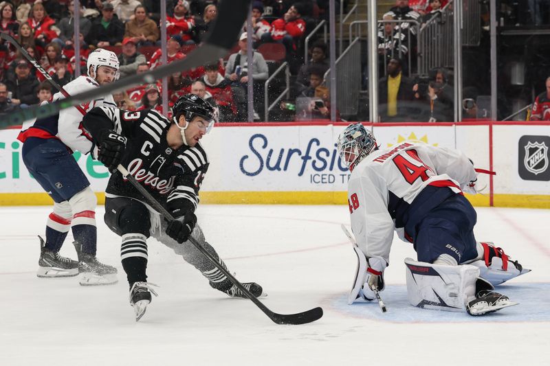 Dec 27, 2025; Newark, New Jersey, USA; Washington Capitals goaltender Logan Thompson (48) makes a save on New Jersey Devils center Nico Hischier (13) during the second period at Prudential Center. Mandatory Credit: Ed Mulholland-Imagn Images