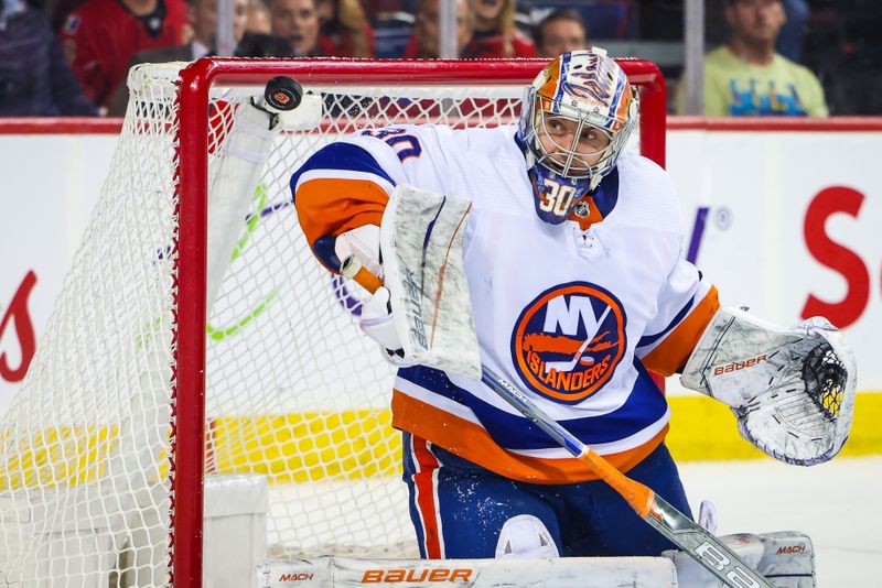 Nov 18, 2023; Calgary, Alberta, CAN; New York Islanders goaltender Ilya Sorokin (30) makes a save against the Calgary Flames during the overtime period at Scotiabank Saddledome. Mandatory Credit: Sergei Belski-USA TODAY Sports