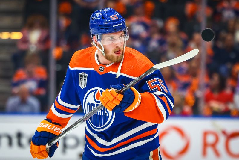 Jun 21, 2024; Edmonton, Alberta, CAN; Edmonton Oilers left wing Dylan Holloway (55) controls the puck during the warmup period against the Florida Panthers in game six of the 2024 Stanley Cup Final at Rogers Place. Mandatory Credit: Sergei Belski-USA TODAY Sports