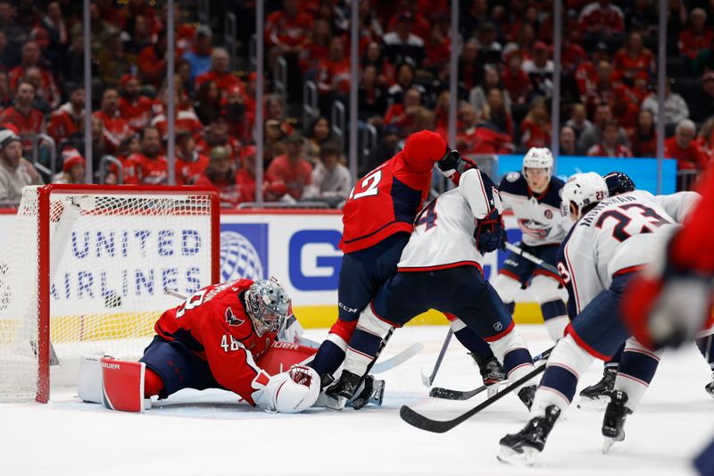 Nov 2, 2024; Washington, District of Columbia, USA; Washington Capitals goaltender Logan Thompson (48) makes a save in front of Capitals defenseman Martin Fehervary (42) and Columbus Blue Jackets center Cole Sillinger (4) in the second period at Capital One Arena. Mandatory Credit: Geoff Burke-Imagn Images