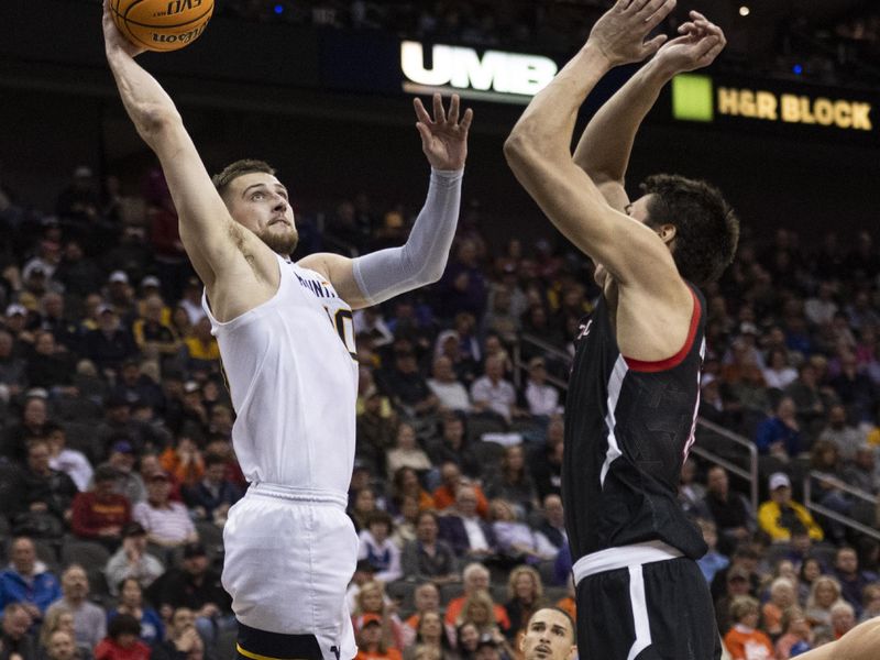 Mar 8, 2023; Kansas City, MO, USA; West Virginia Mountaineers guard Erik Stevenson (10) shoots the ball against Texas Tech Red Raiders forward Daniel Batcho (12) in the second half at T-Mobile Center. Mandatory Credit: Amy Kontras-USA TODAY Sports