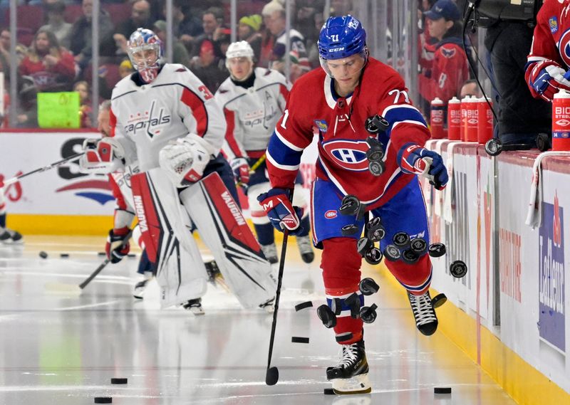 Feb 17, 2024; Montreal, Quebec, CAN; Montreal Canadiens forward Jake Evans (71) throws pucks on the ice during the warmup period before the game against the Washington Capitals at the Bell Centre. Mandatory Credit: Eric Bolte-USA TODAY Sports