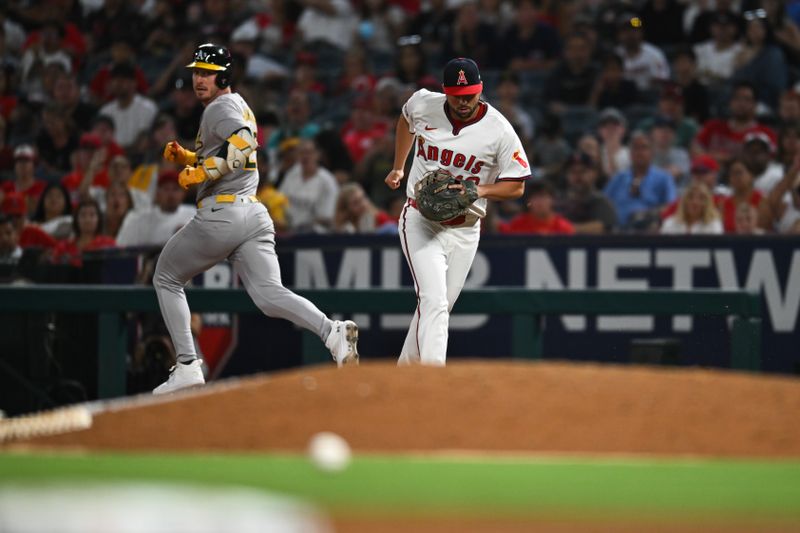 Jul 27, 2024; Anaheim, California, USA; Oakland Athletics designated hitter Brent Rooker (25) singles against Los Angeles Angels first baseman Nolan Schanuel (18) during the eighth inning at Angel Stadium. Mandatory Credit: Jonathan Hui-USA TODAY Sports