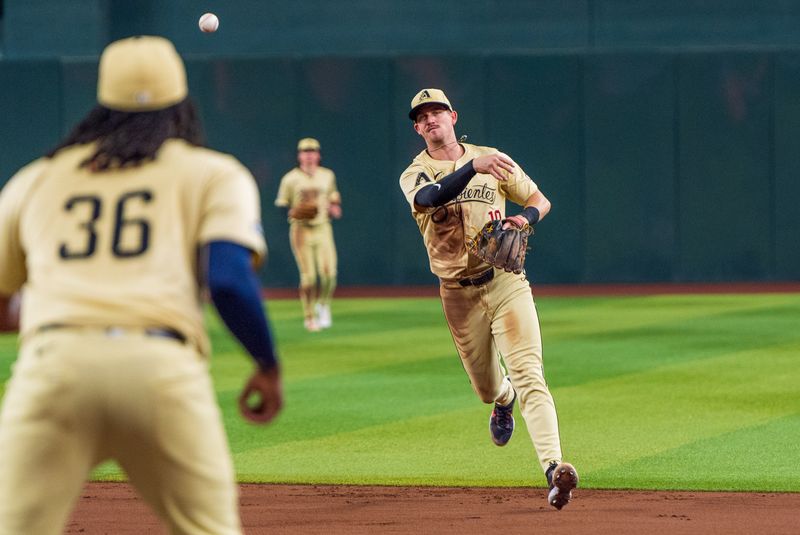 Aug 30, 2024; Phoenix, Arizona, USA; Arizona Diamondbacks shortstop Kevin Newman (18) makes the out to end the sixth inning against the Los Angeles Dodgers at Chase Field. Mandatory Credit: Allan Henry-USA TODAY Sports 