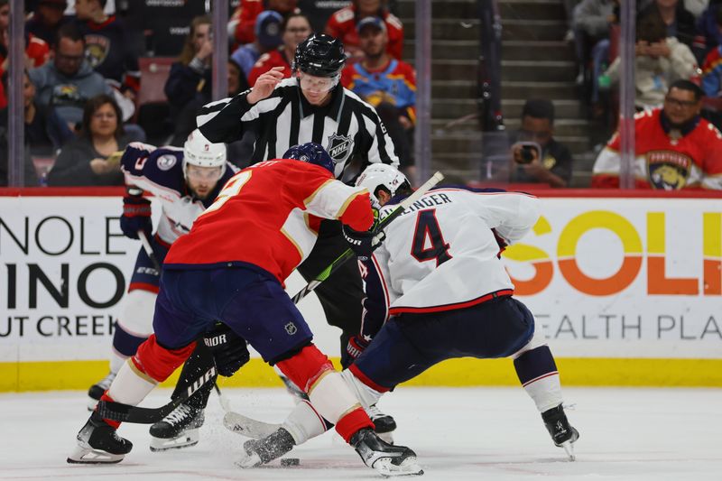 Apr 11, 2024; Sunrise, Florida, USA; Florida Panthers right wing Kyle Okposo (8) and Columbus Blue Jackets center Cole Sillinger (4) face-off during the second period at Amerant Bank Arena. Mandatory Credit: Sam Navarro-USA TODAY Sports