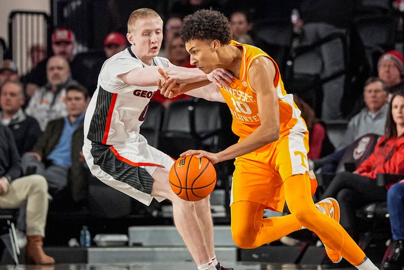 Jan 28, 2026; Athens, Georgia, USA; Tennessee Volunteers forward Nate Ament (10) dribbles against Georgia Bulldogs guard Blue Cain (0) at Stegeman Coliseum. Mandatory Credit: Dale Zanine-Imagn Images