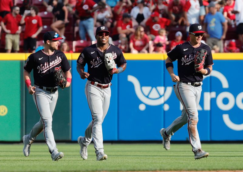 Aug 5, 2023; Cincinnati, Ohio, USA; Washington Nationals outfielders Lane Thomas (left) Stone Garrett (middle) and  Alex Call (right) run off the field after the Nationals defeated the Cincinnati Reds at Great American Ball Park. Mandatory Credit: David Kohl-USA TODAY Sports