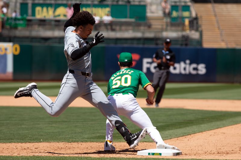 Aug 7, 2024; Oakland, California, USA; Chicago White Sox designated hitter Miguel Vargas (20) cannot beat the throw to Oakland Athletics first baseman Armando Alvarez (50) during the seventh inning at Oakland-Alameda County Coliseum. Mandatory Credit: D. Ross Cameron-USA TODAY Sports