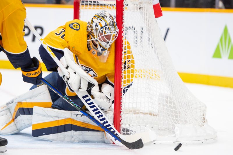 Feb 15, 2024; Nashville, Tennessee, USA; Nashville Predators goalie Kevin Lankinen (32) blocks the puck against the Dallas Stars during the second period at Bridgestone Arena. Mandatory Credit: Steve Roberts-USA TODAY Sports