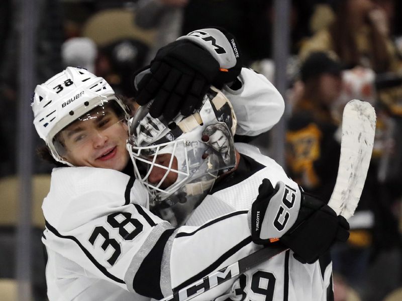 Feb 18, 2024; Pittsburgh, Pennsylvania, USA;  Los Angeles Kings center Alex Turcotte (38) and goaltender Cam Talbot (39) celebrate after defeating the Pittsburgh Penguins at PPG Paints Arena. Los Angeles won 2-1. Mandatory Credit: Charles LeClaire-USA TODAY Sports