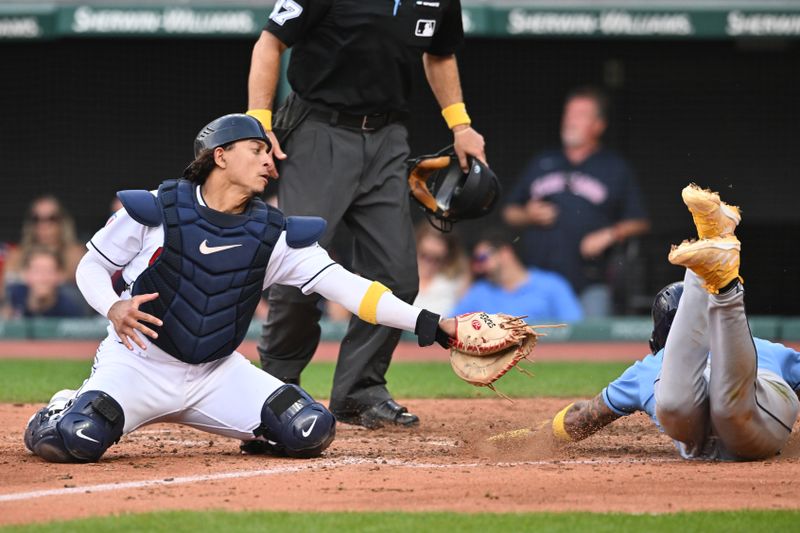 Sep 3, 2023; Cleveland, Ohio, USA; Tampa Bay Rays center fielder Jose Siri (22) is safe at home as Cleveland Guardians catcher Bo Naylor (23) is late with the tag during the eighth inning at Progressive Field. Mandatory Credit: Ken Blaze-USA TODAY Sports