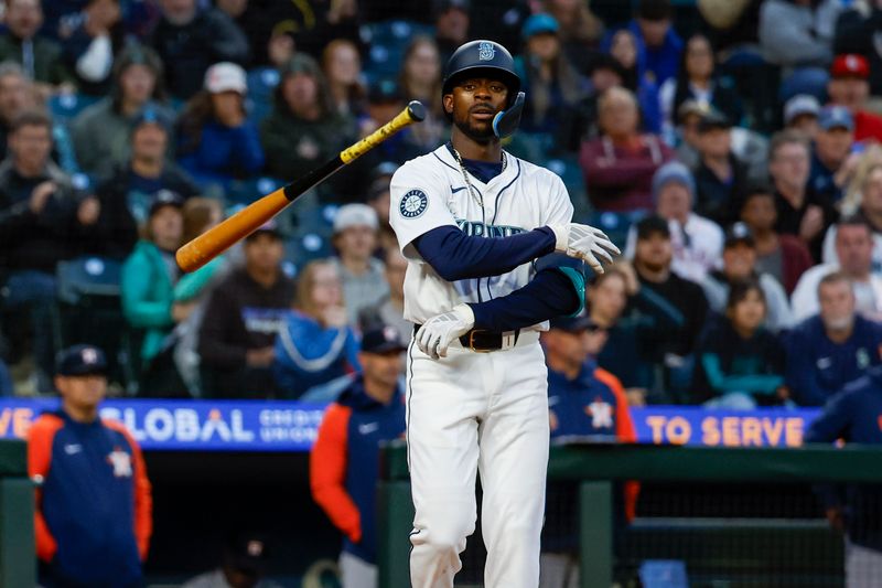 May 28, 2024; Seattle, Washington, USA; Seattle Mariners second baseman Ryan Bliss (1) tosses his bat after drawing a walk against the Houston Astros during the eighth inning at T-Mobile Park. Mandatory Credit: Joe Nicholson-USA TODAY Sports