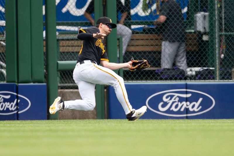 May 5, 2024; Pittsburgh, Pennsylvania, USA; Pittsburgh Pirates left fielder Bryan Reynolds (10) makes a sliding catch for the first out of the first inning against the Colorado Rockies at PNC Park. Mandatory Credit: Scott Galvin-USA TODAY Sports