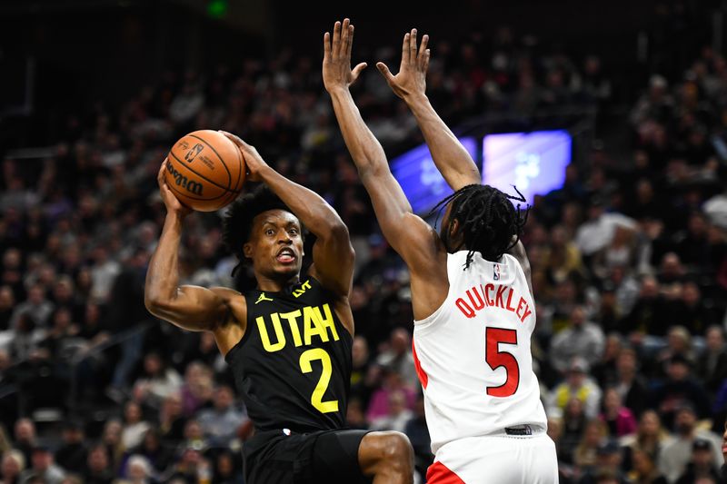 SALT LAKE CITY, UTAH - JANUARY 12: Collin Sexton #2 of the Utah Jazz passes around Immanuel Quickley #5 of the Toronto Raptors during the first half of a game at Delta Center on January 12, 2024 in Salt Lake City, Utah. NOTE TO USER: User expressly acknowledges and agrees that, by downloading and or using this photograph, User is consenting to the terms and conditions of the Getty Images License Agreement. (Photo by Alex Goodlett/Getty Images)