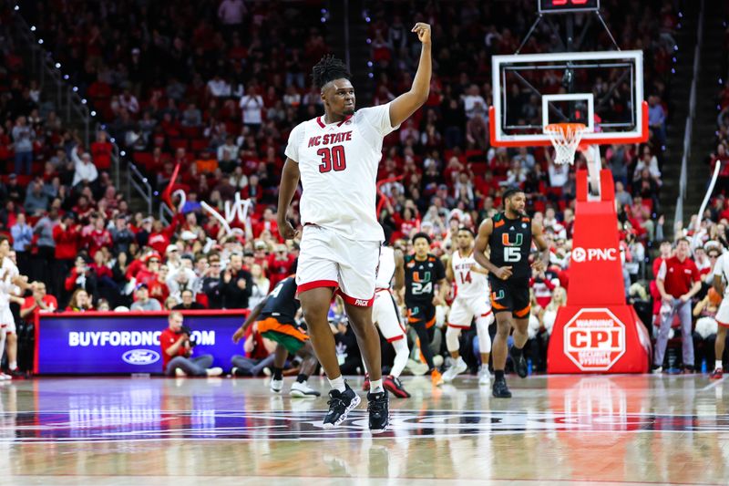 Jan 14, 2023; Raleigh, North Carolina, USA;  North Carolina State Wolfpack forward D.J. Burns Jr. (30) pumps up the crowd during the second half against Miami Hurricanes at PNC Arena. Mandatory Credit: Jaylynn Nash-USA TODAY Sports