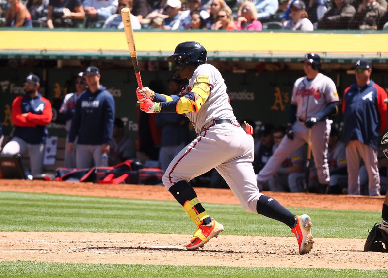 May 31, 2023; Oakland, California, USA; Atlanta Braves right fielder Ronald Acuna Jr. (13) hits an RBI-single during the seventh inning against the Oakland Athletics at Oakland-Alameda County Coliseum. Mandatory Credit: Kelley L Cox-USA TODAY Sports