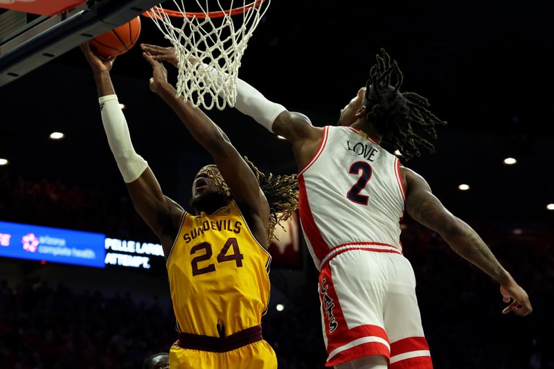 Feb 17, 2024; Tucson, Arizona, USA; Arizona State Sun Devils forward Bryant Selebangue (24) shoots a basket against Arizona Wildcats guard Caleb Love (2) during the first half at McKale Center. Mandatory Credit: Zachary BonDurant-USA TODAY Sports