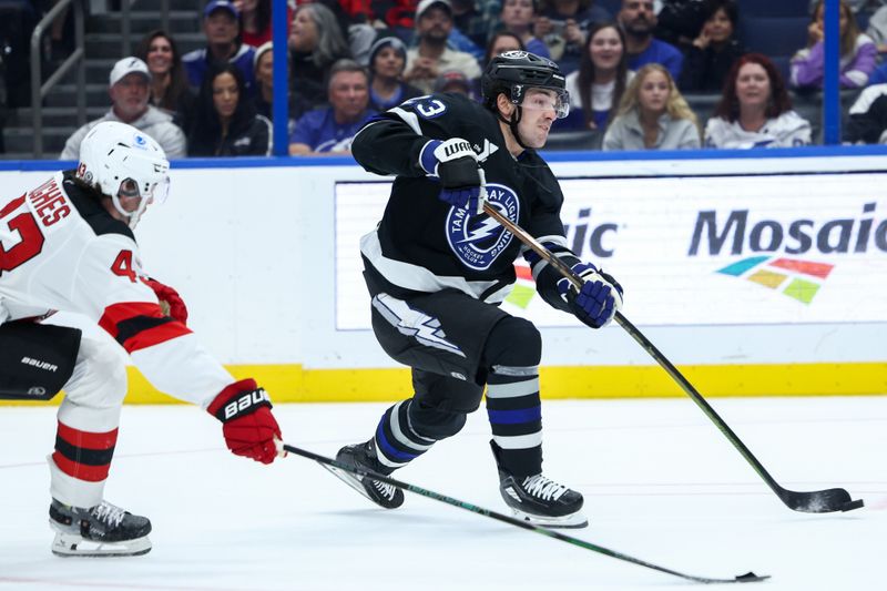 Nov 16, 2024; Tampa, Florida, USA; Tampa Bay Lightning center Michael Eyssimont (23) shoots the puck against the New Jersey Devils in the third period at Amalie Arena. Mandatory Credit: Nathan Ray Seebeck-Imagn Images