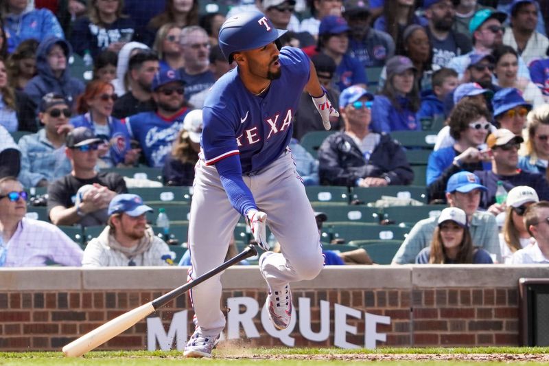 Apr 9, 2023; Chicago, Illinois, USA; Texas Rangers second baseman Marcus Semien (2) hits a one run single against the Chicago Cubs during the sixth inning at Wrigley Field. Mandatory Credit: David Banks-USA TODAY Sports