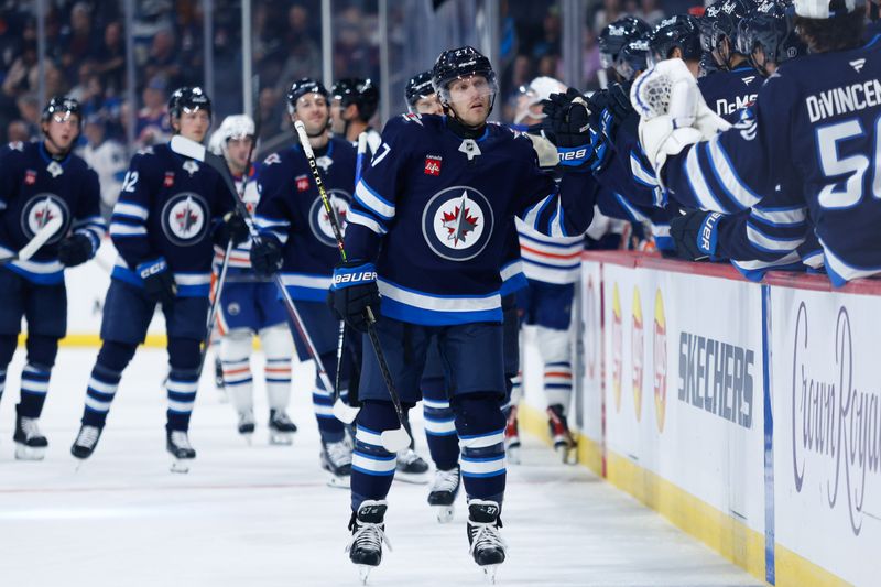 Sep 25, 2024; Winnipeg, Manitoba, CAN; Winnipeg Jets forward Nikolaj Ehlers (27) is congratulated by his teammates on his goal against the Edmonton Oilers during the first period at Canada Life Centre. Mandatory Credit: Terrence Lee-Imagn Images