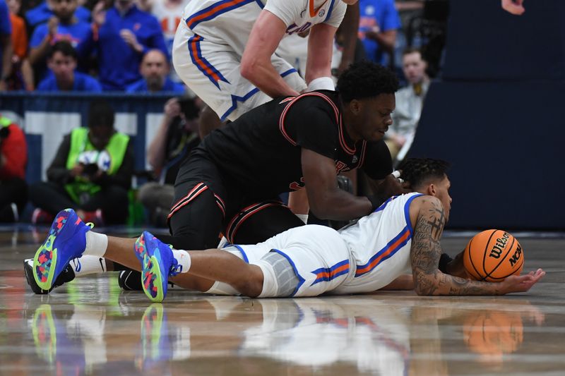 Mar 14, 2024; Nashville, TN, USA; Florida Gators guard Will Richard (5) and Georgia Bulldogs center Russel Tchewa (54) work for a loose ball during the first half at Bridgestone Arena. Mandatory Credit: Christopher Hanewinckel-USA TODAY Sports