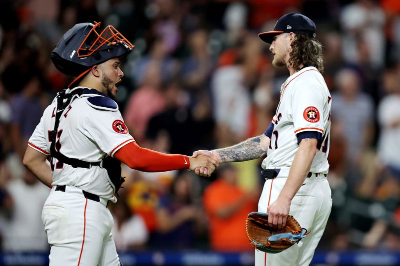 Jul 31, 2024; Houston, Texas, USA; Houston Astros catcher Yainer Diaz (21) and relief pitcher Josh Hader (71) congratulate each other following the final out against the Pittsburgh Pirates during the ninth inning at Minute Maid Park. Mandatory Credit: Erik Williams-USA TODAY Sports