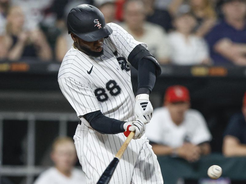 Jul 4, 2023; Chicago, Illinois, USA; Chicago White Sox center fielder Luis Robert Jr. (88) hits a three-run home run against the Toronto Blue Jays during the sixth inning at Guaranteed Rate Field. Mandatory Credit: Kamil Krzaczynski-USA TODAY Sports