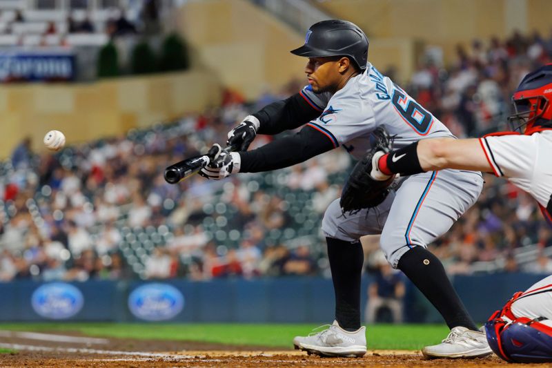 Sep 24, 2024; Minneapolis, Minnesota, USA; Miami Marlins shortstop Xavier Edwards (63) bunts for a single against the Minnesota Twins in the fourth inning at Target Field. Mandatory Credit: Bruce Kluckhohn-Imagn Images